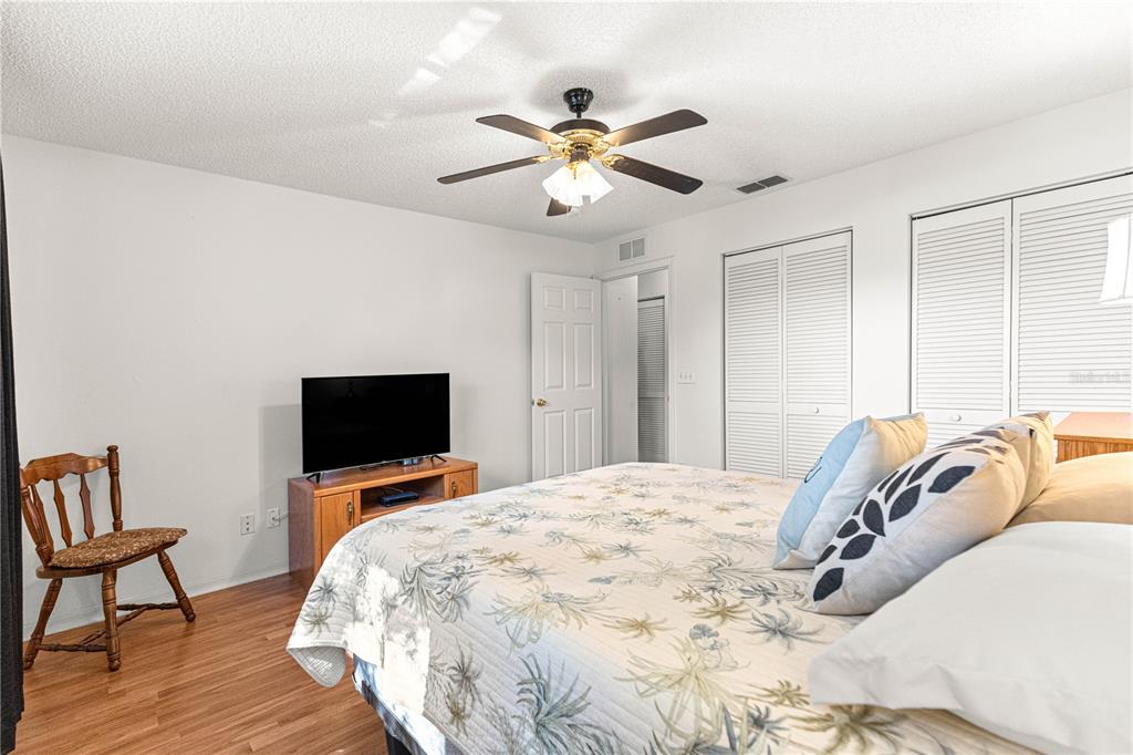 8962 Southwest 97th Street, Unit D Ocala, FL 34481 - Photo 29 of 56 a bedroom with a bed and a flat screen tv