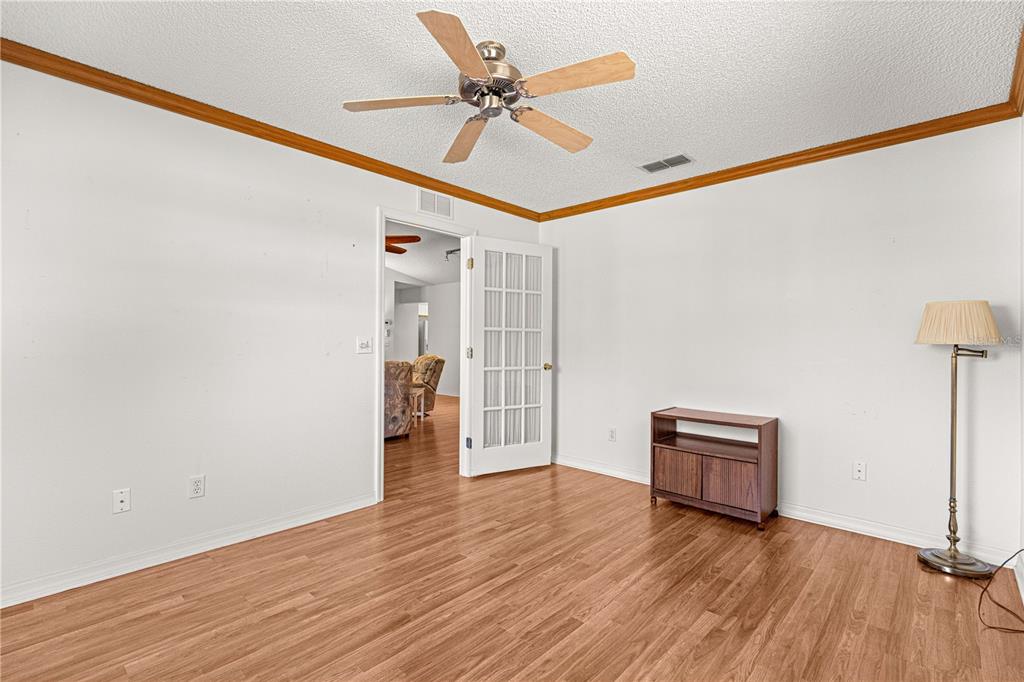 8962 Southwest 97th Street, Unit D Ocala, FL 34481 - Photo 32 of 56 a view of an empty room with a window and wooden floor
