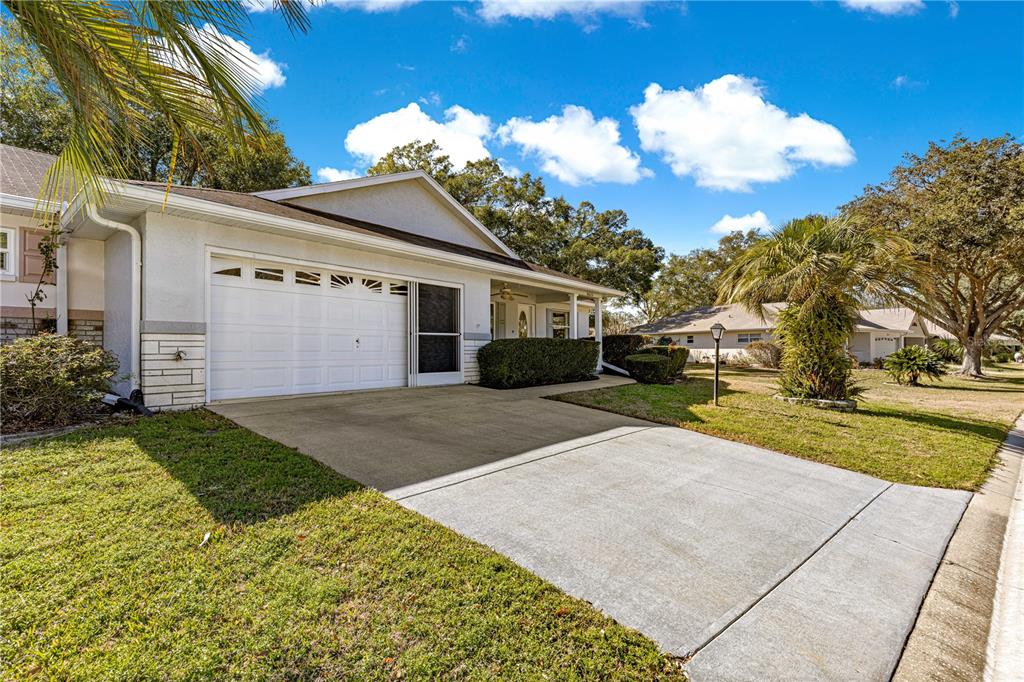 8962 Southwest 97th Street, Unit D Ocala, FL 34481 - Photo 39 of 56 a front view of a house with a yard and garage