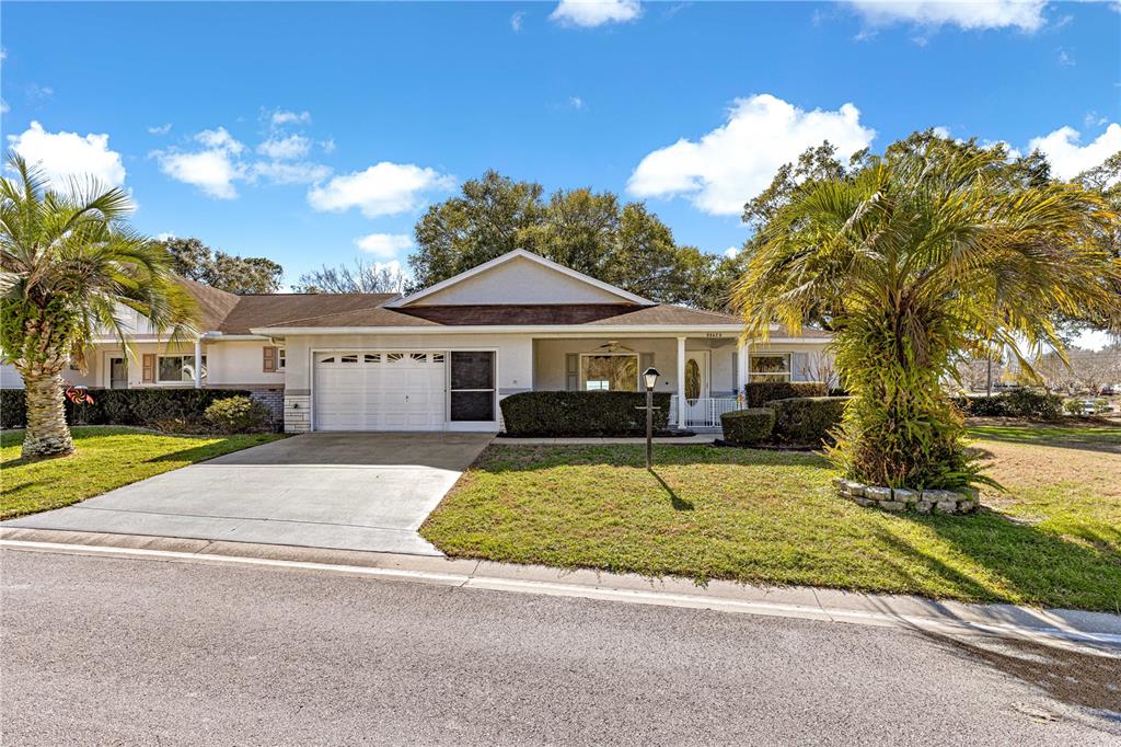 8962 Southwest 97th Street, Unit D Ocala, FL 34481 - Photo 40 of 56 a front view of a house with a yard and garage