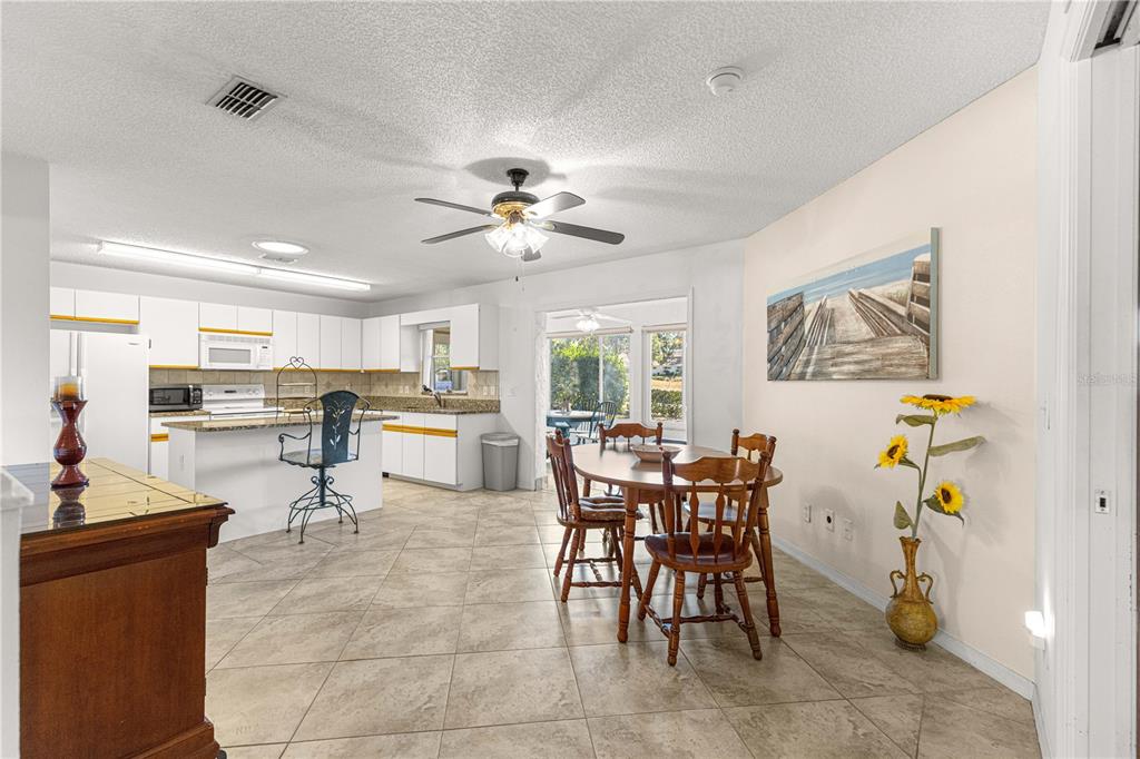 8962 Southwest 97th Street, Unit D Ocala, FL 34481 - Photo 4 of 56 a living room with furniture a dining table and kitchen view