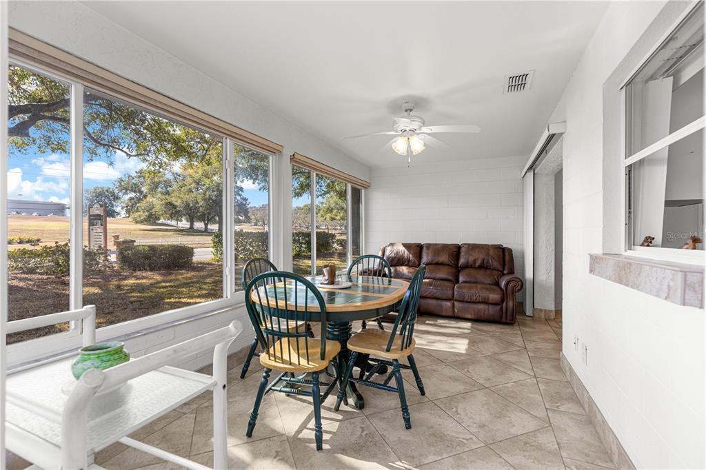 8962 Southwest 97th Street, Unit D Ocala, FL 34481 - Photo 5 of 56 a dining room with furniture a chandelier and wooden floor