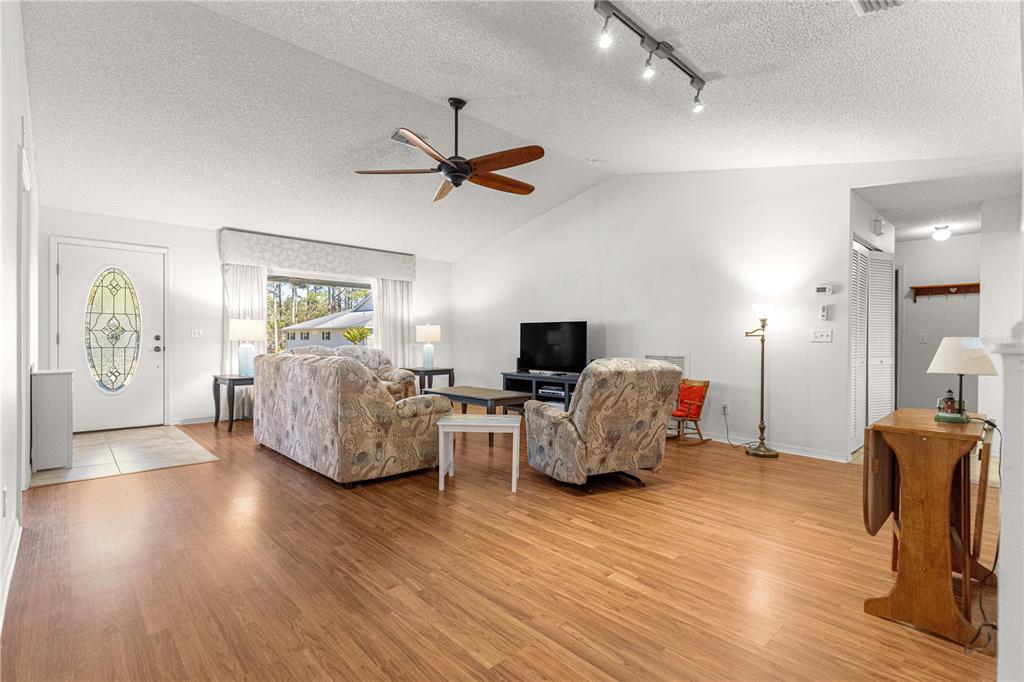 8962 Southwest 97th Street, Unit D Ocala, FL 34481 - Photo 7 of 56 a living room with furniture and a flat screen tv