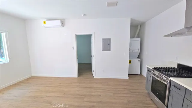 a kitchen with a refrigerator and a stove top oven