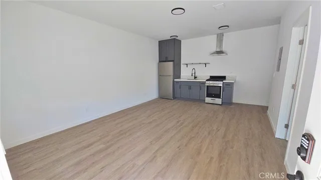 a view of a kitchen with a sink and a refrigerator