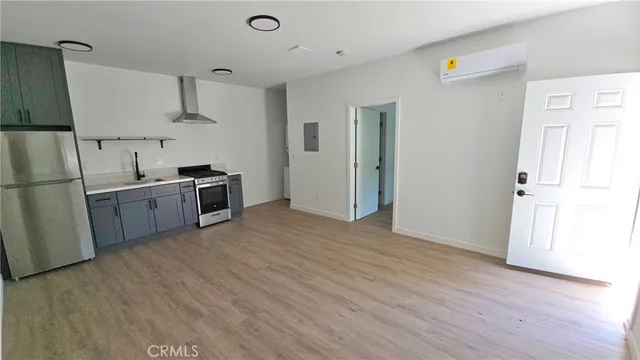 a kitchen with stainless steel appliances a refrigerator and a stove top oven