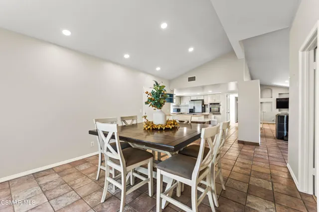 a living room with furniture chandelier and a large window