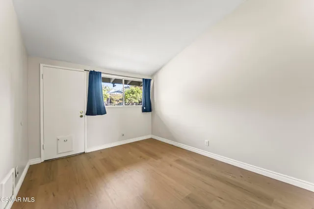 a bedroom with bed and a window