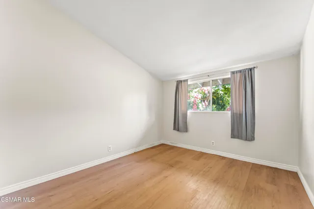 a bedroom with bed and painting on the wall