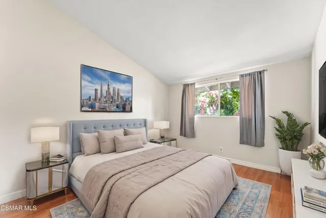 an empty room with wooden floor and sliding door