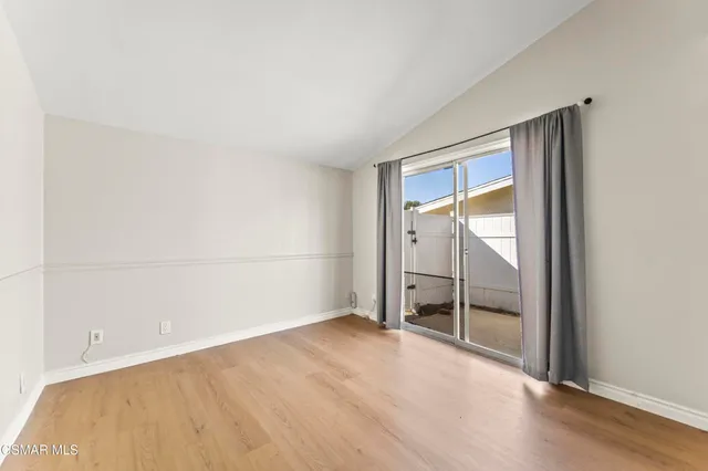 a bedroom with a large bed and a potted plant