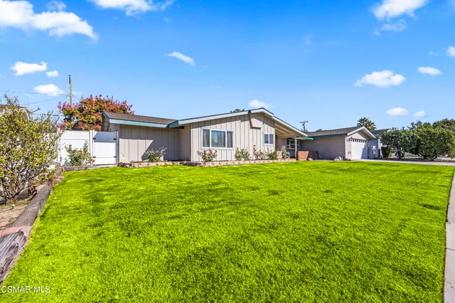 a wooden bench sitting in front of a building
