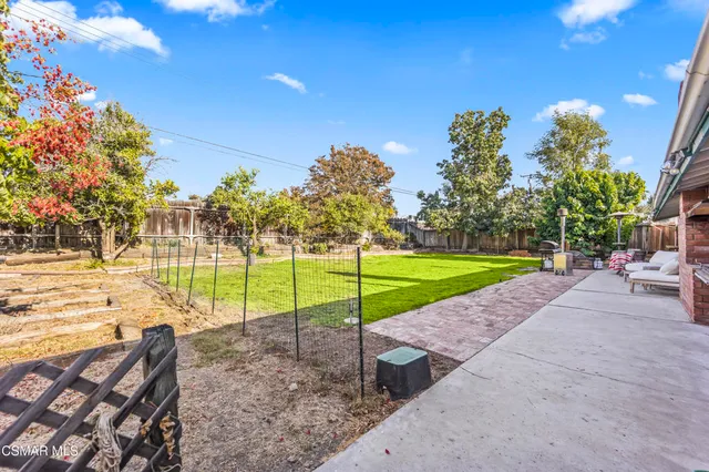 a view of a patio with table and chairs and potted plants