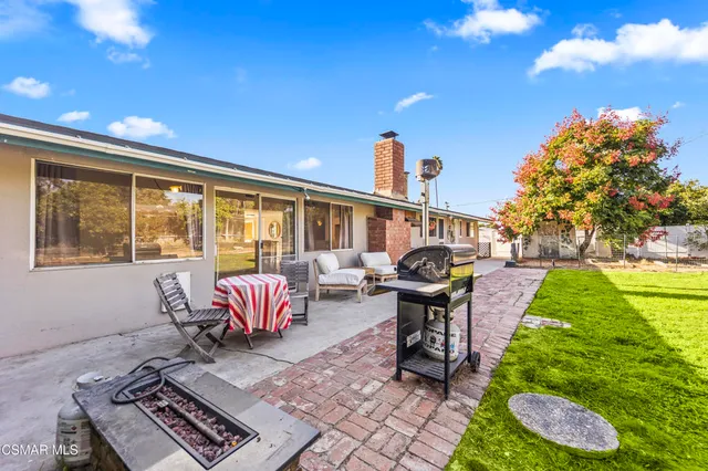 a view of a swimming pool with a patio and a yard