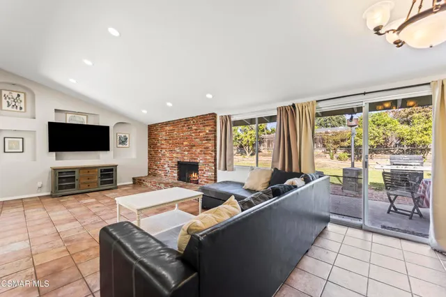 a living room with furniture a fireplace and a rug