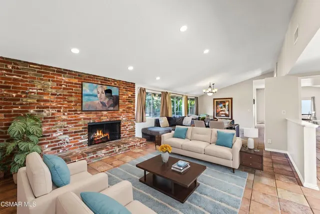 a view of a dining room and livingroom with furniture wooden floor and a rug