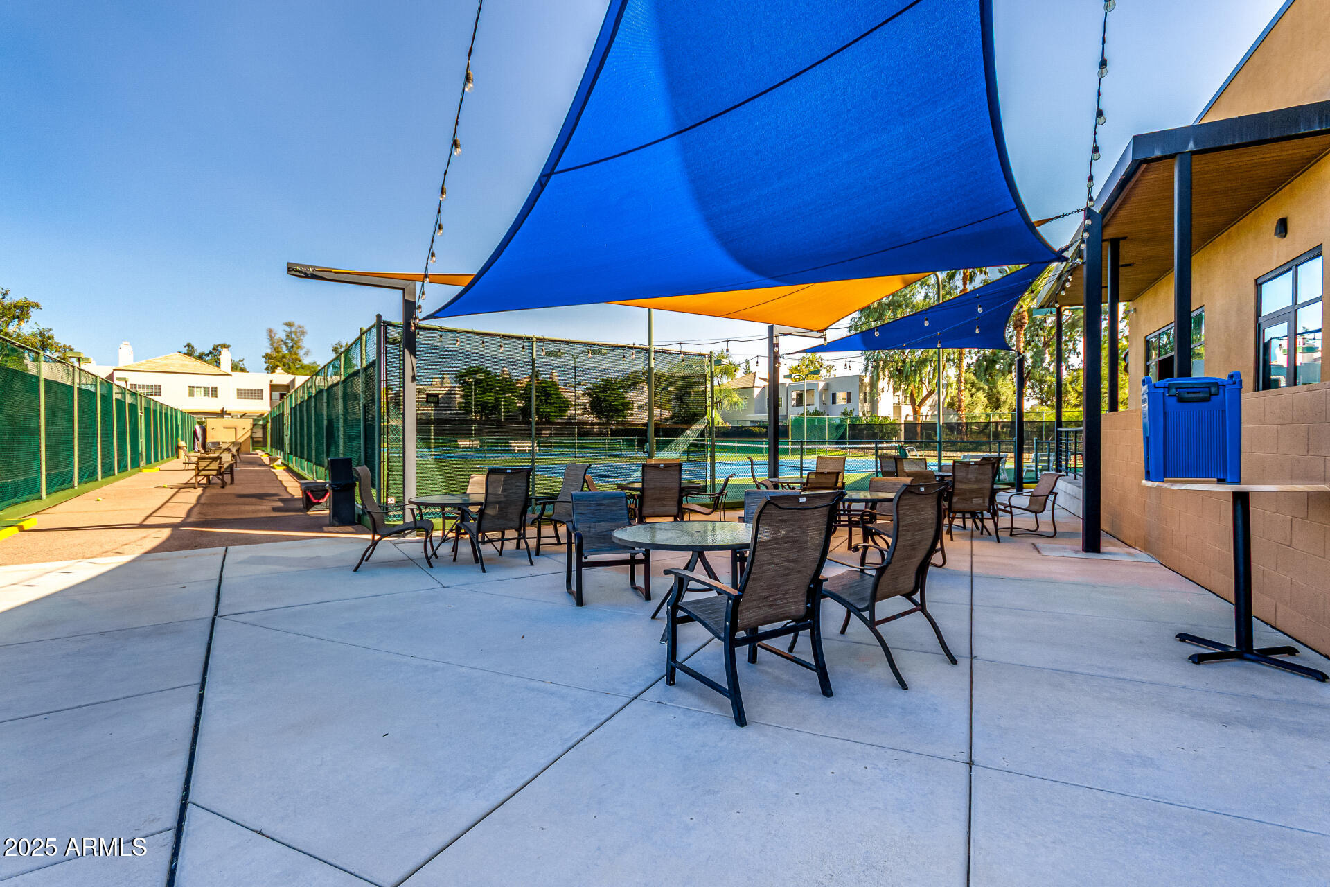 7222 East Gainey Ranch Road, Unit 241 Scottsdale, AZ 85258 - Photo 23 of 74 a view of a patio with table and chairs under an umbrella