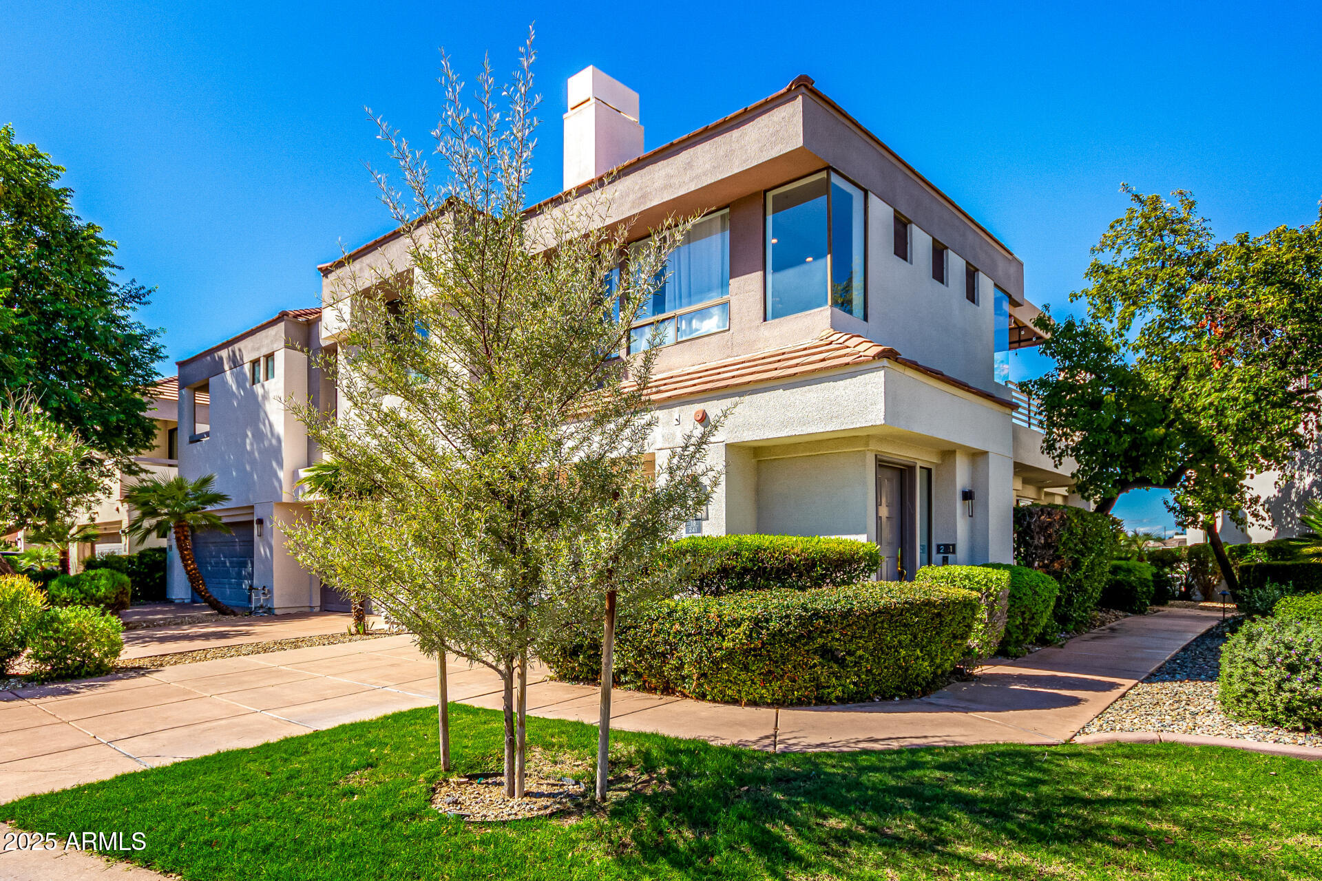 7222 East Gainey Ranch Road, Unit 241 Scottsdale, AZ 85258 - Photo 34 of 74 a front view of a house with a yard