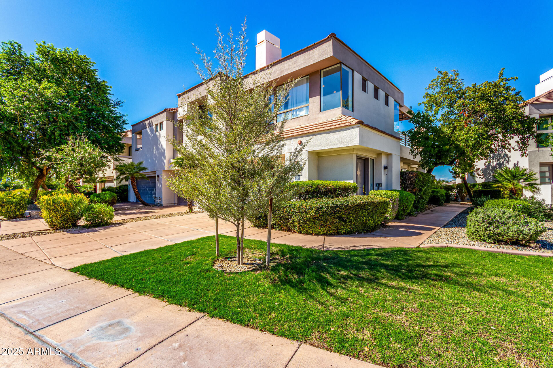 7222 East Gainey Ranch Road, Unit 241 Scottsdale, AZ 85258 - Photo 35 of 74 a front view of a house with a yard