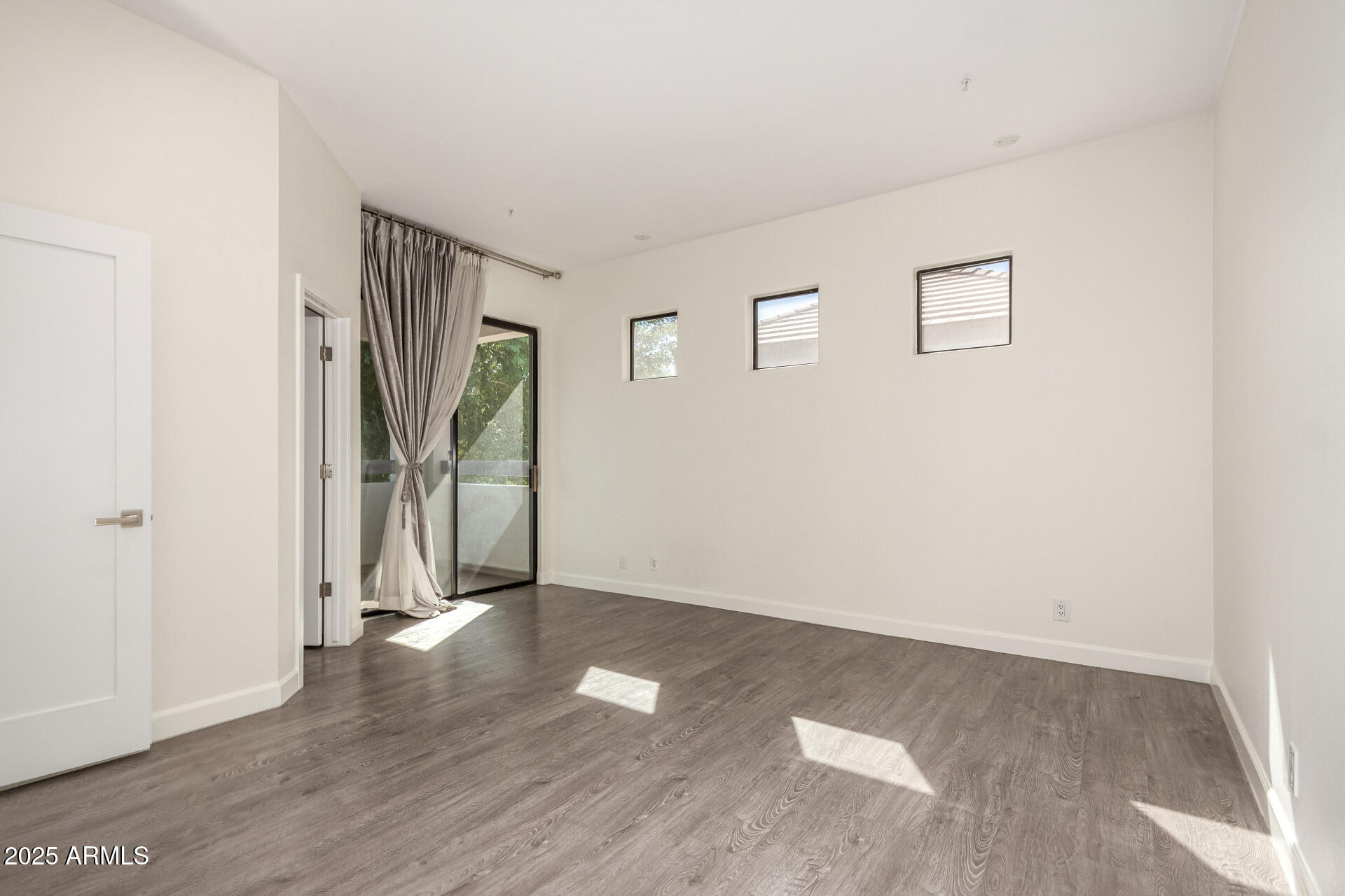 7222 East Gainey Ranch Road, Unit 241 Scottsdale, AZ 85258 - Photo 40 of 74 an empty room with wooden floor and a ceiling fan