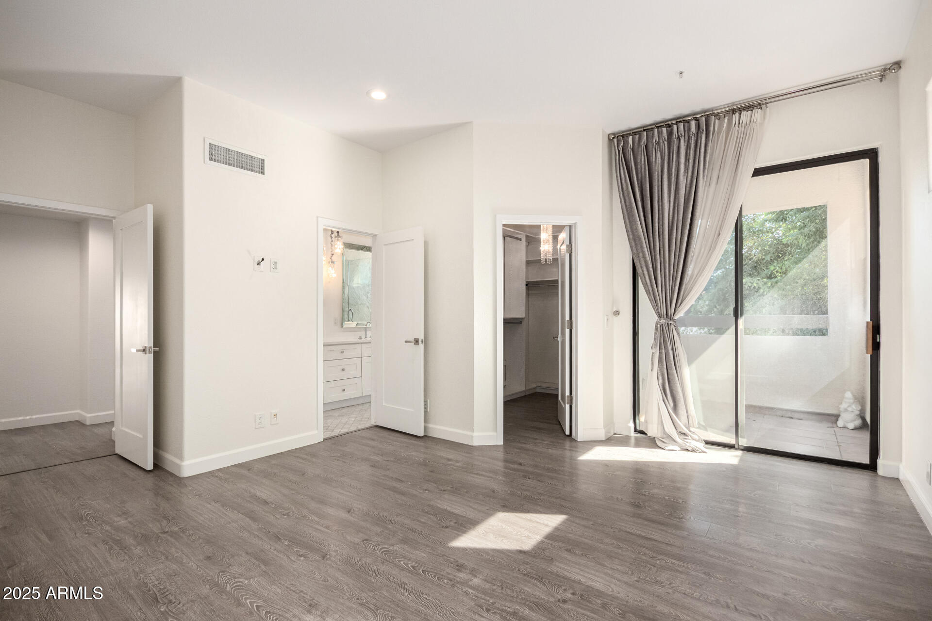 7222 East Gainey Ranch Road, Unit 241 Scottsdale, AZ 85258 - Photo 41 of 74 wooden floor in an empty room with a window