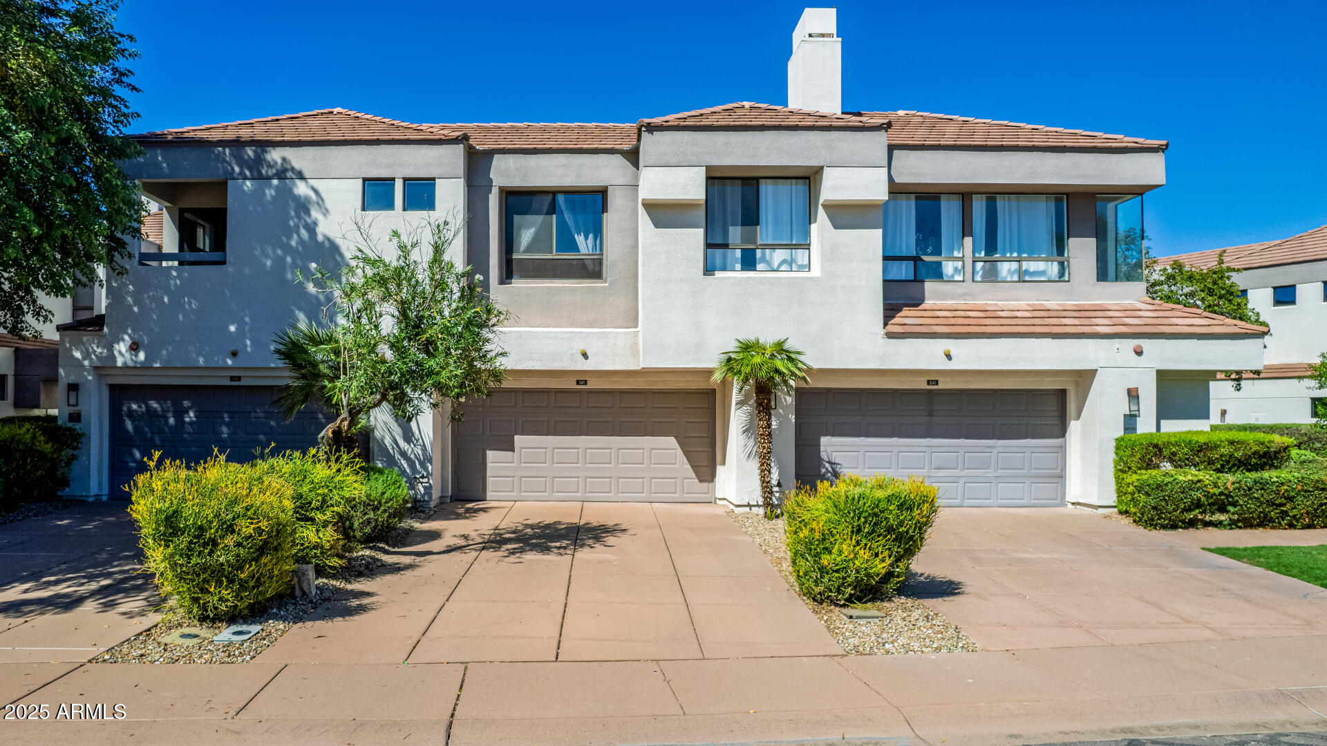 7222 East Gainey Ranch Road, Unit 241 Scottsdale, AZ 85258 - Photo 44 of 74 a front view of a house with a garden