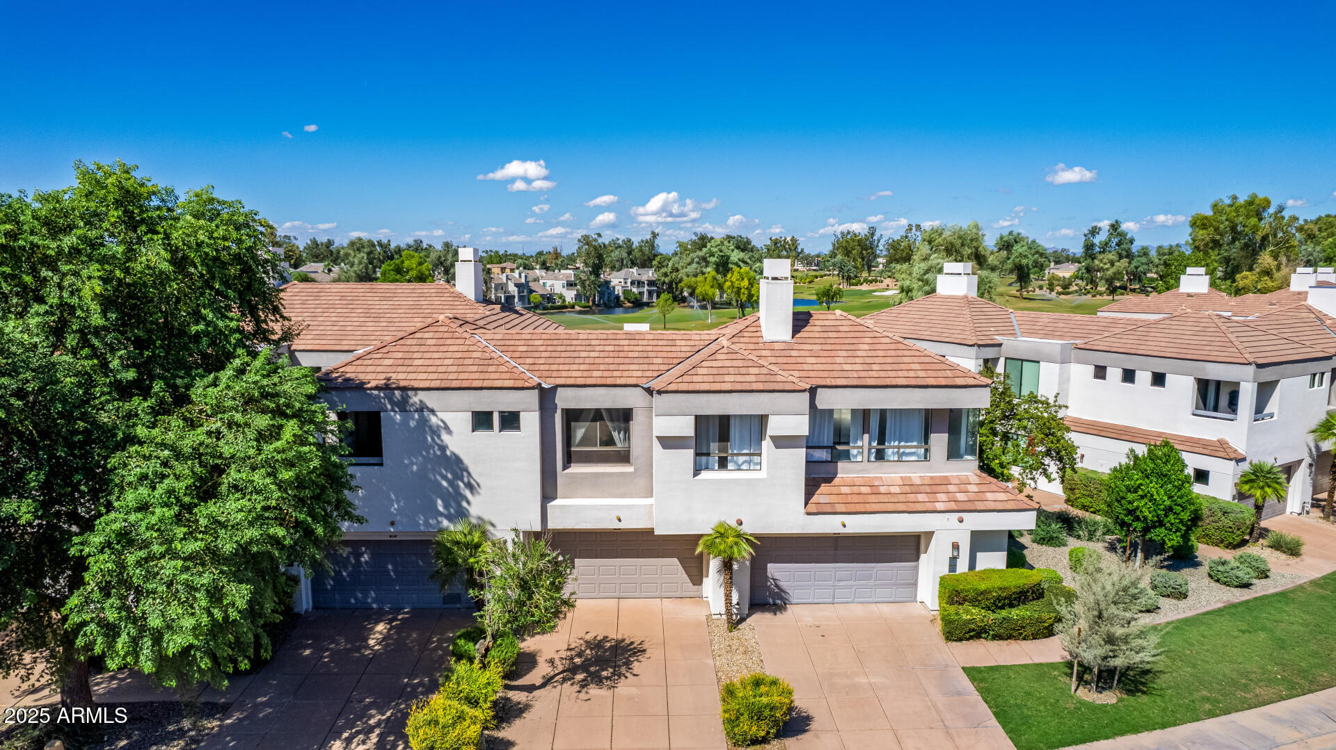 7222 East Gainey Ranch Road, Unit 241 Scottsdale, AZ 85258 - Photo 48 of 74 a view of a house with a yard and potted plants