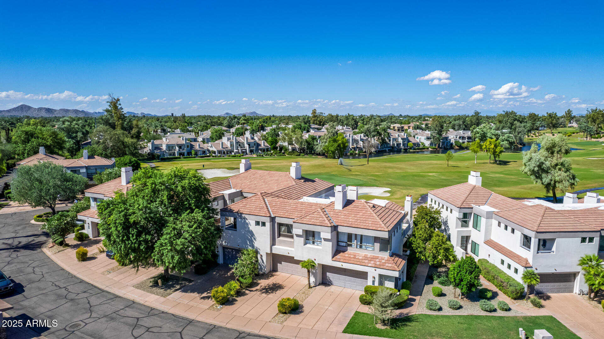 7222 East Gainey Ranch Road, Unit 241 Scottsdale, AZ 85258 - Photo 50 of 74 an aerial view of a house with a garden and lake view