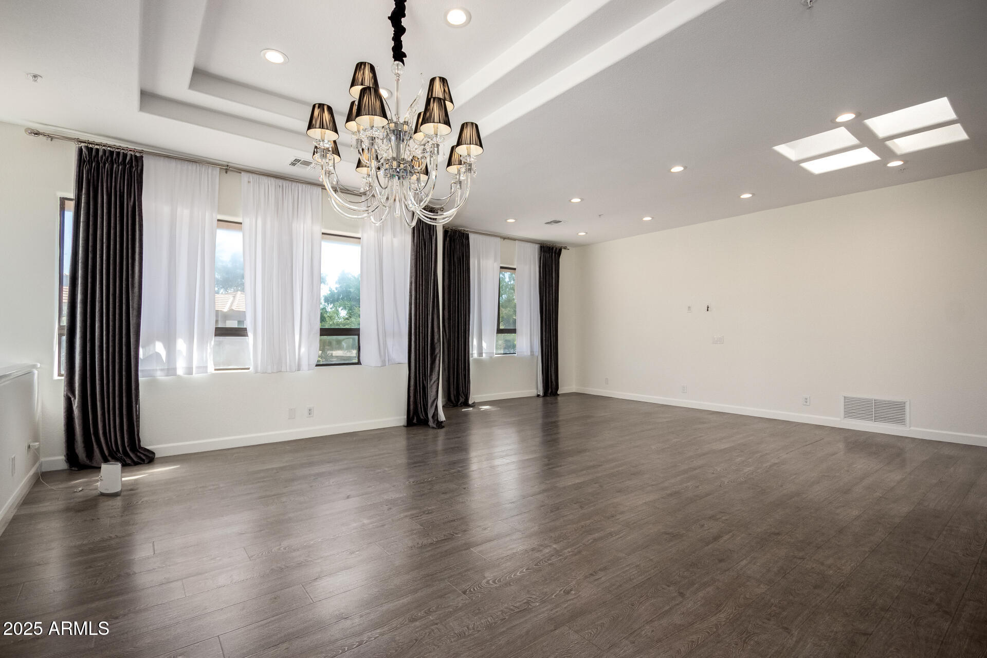 7222 East Gainey Ranch Road, Unit 241 Scottsdale, AZ 85258 - Photo 5 of 74 a view of an empty room with wooden floor and a window
