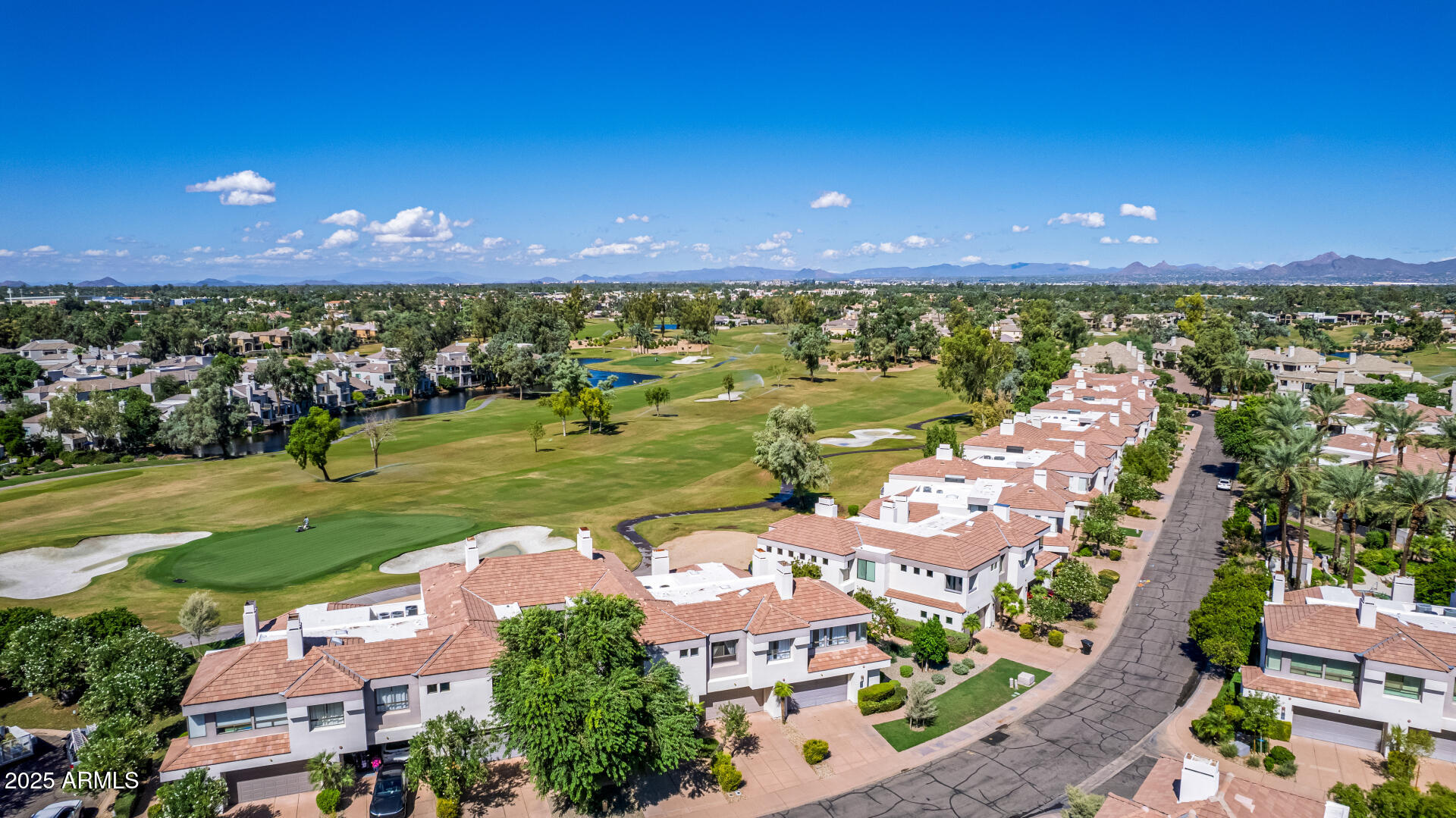 7222 East Gainey Ranch Road, Unit 241 Scottsdale, AZ 85258 - Photo 52 of 74 an aerial view of a city with lots of residential buildings ocean and mountain view in back