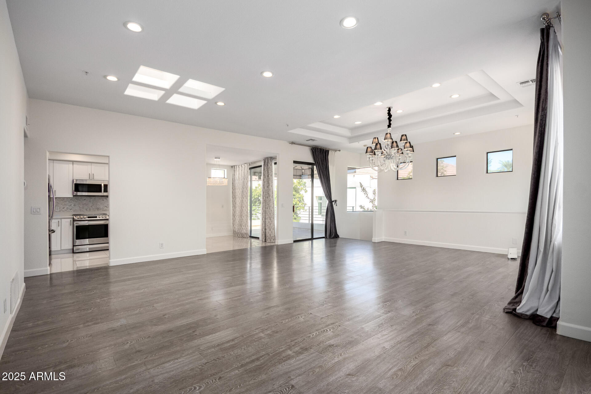 7222 East Gainey Ranch Road, Unit 241 Scottsdale, AZ 85258 - Photo 6 of 74 a view of a livingroom with a furniture wooden floor and a kitchen