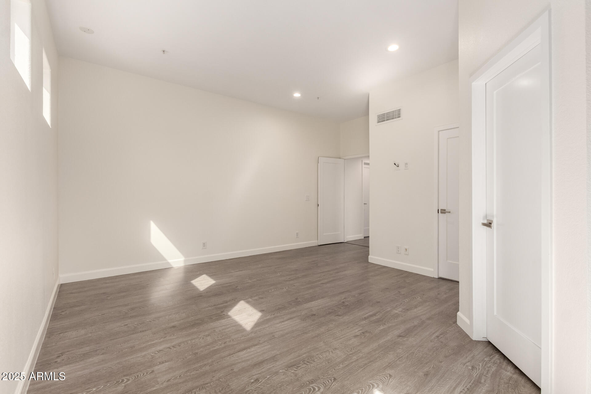 7222 East Gainey Ranch Road, Unit 241 Scottsdale, AZ 85258 - Photo 67 of 74 a view of an empty room with wooden floor and a window