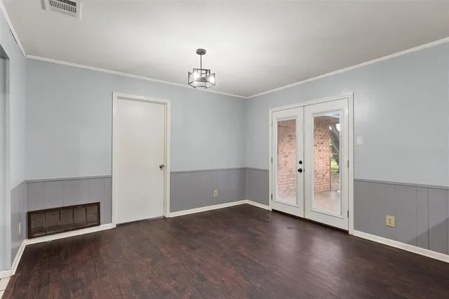 an empty room with windows and fireplace