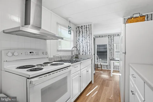 a kitchen with granite countertop a sink stove and refrigerator