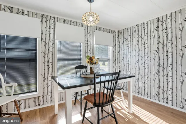 a dining room with furniture and wooden floor