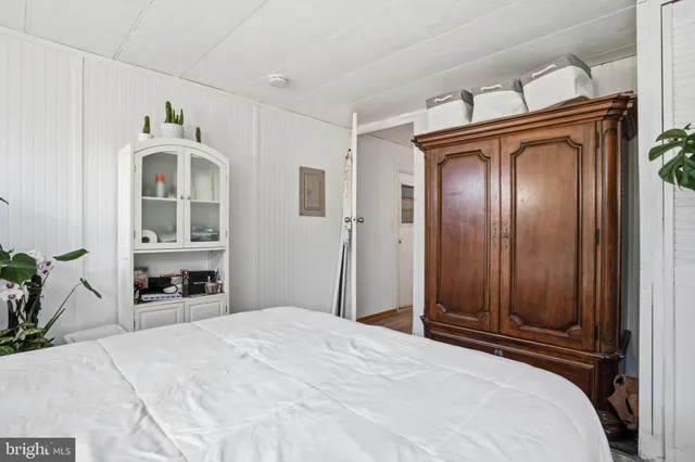 a bedroom with a bed and a large mirror