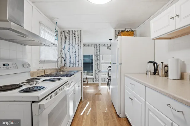 a kitchen with a sink stove and refrigerator
