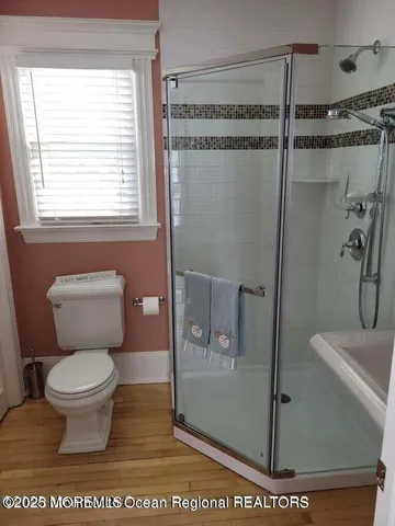 a bathroom with a toilet and a shower