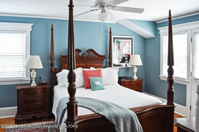 a bedroom with a bed and dresser with mirror