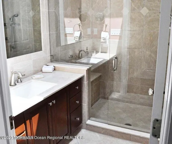 a bathroom with a sink vanity and a mirror