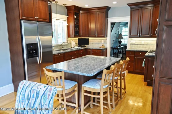 a kitchen with a table chairs refrigerator and cabinets