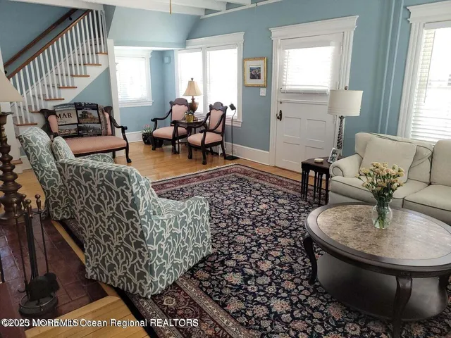 a living room with furniture and a chandelier