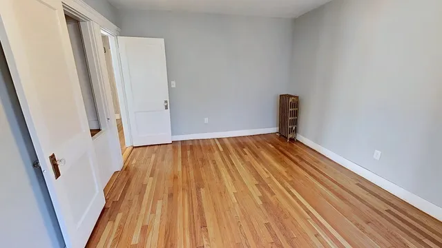 a view of a room with wooden floor and staircase