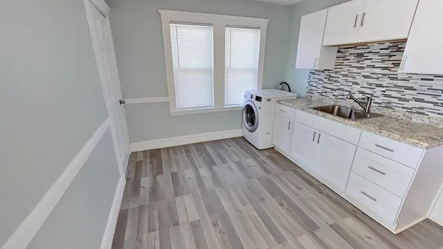 a kitchen with wooden floors and white appliances