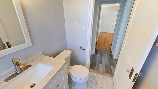 a white toilet sitting next to a bathroom sink
