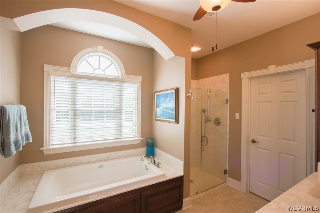 11908 Winterpock Road Chesterfield, VA 23838 - Photo 19 of 50 a spacious bathroom with a bathtub a shower a sink and a window