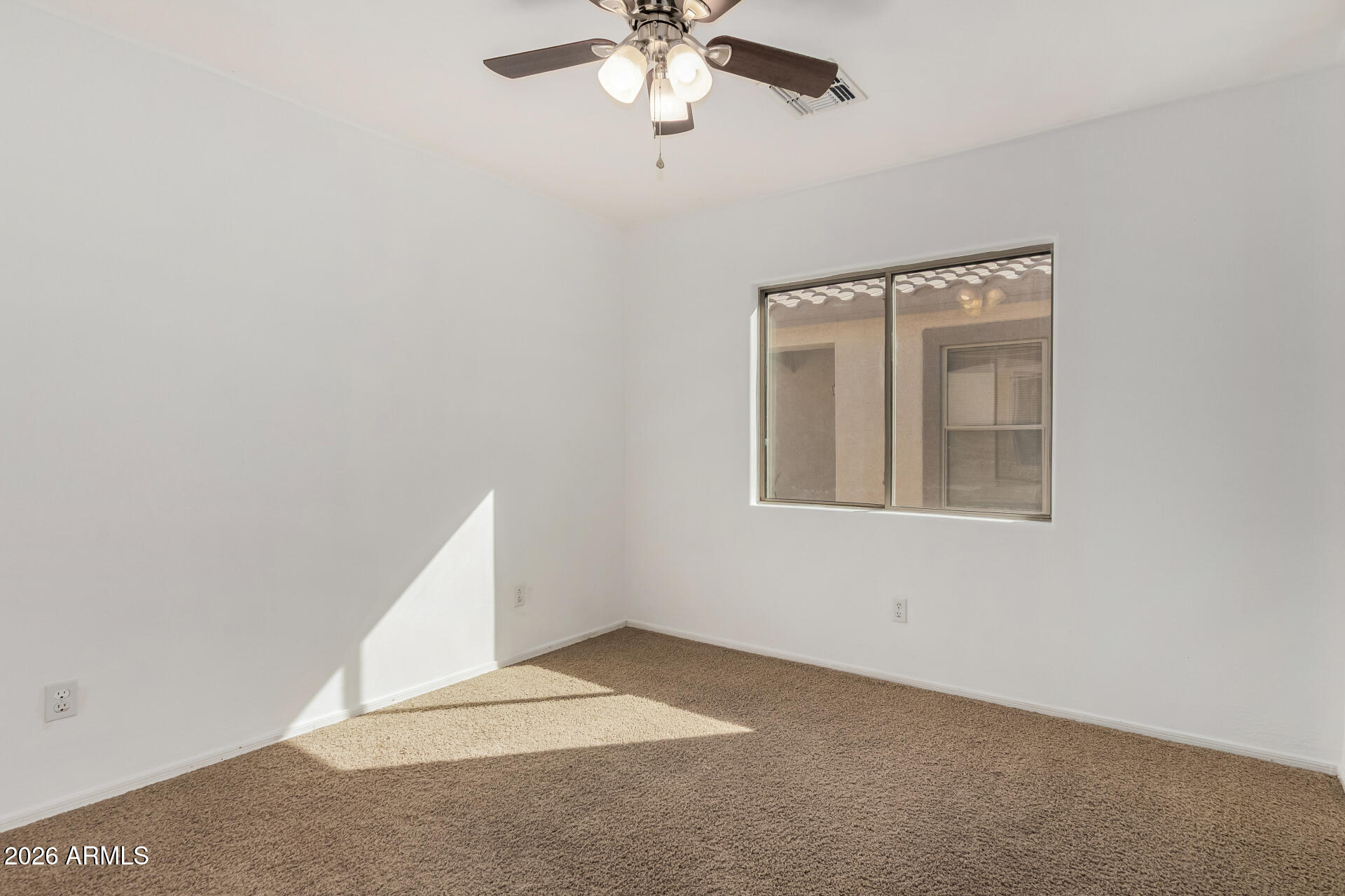 43845 West Elizabeth Avenue Maricopa, AZ 85138 - Photo 23 of 30 a view of a livingroom with a ceiling fan and window