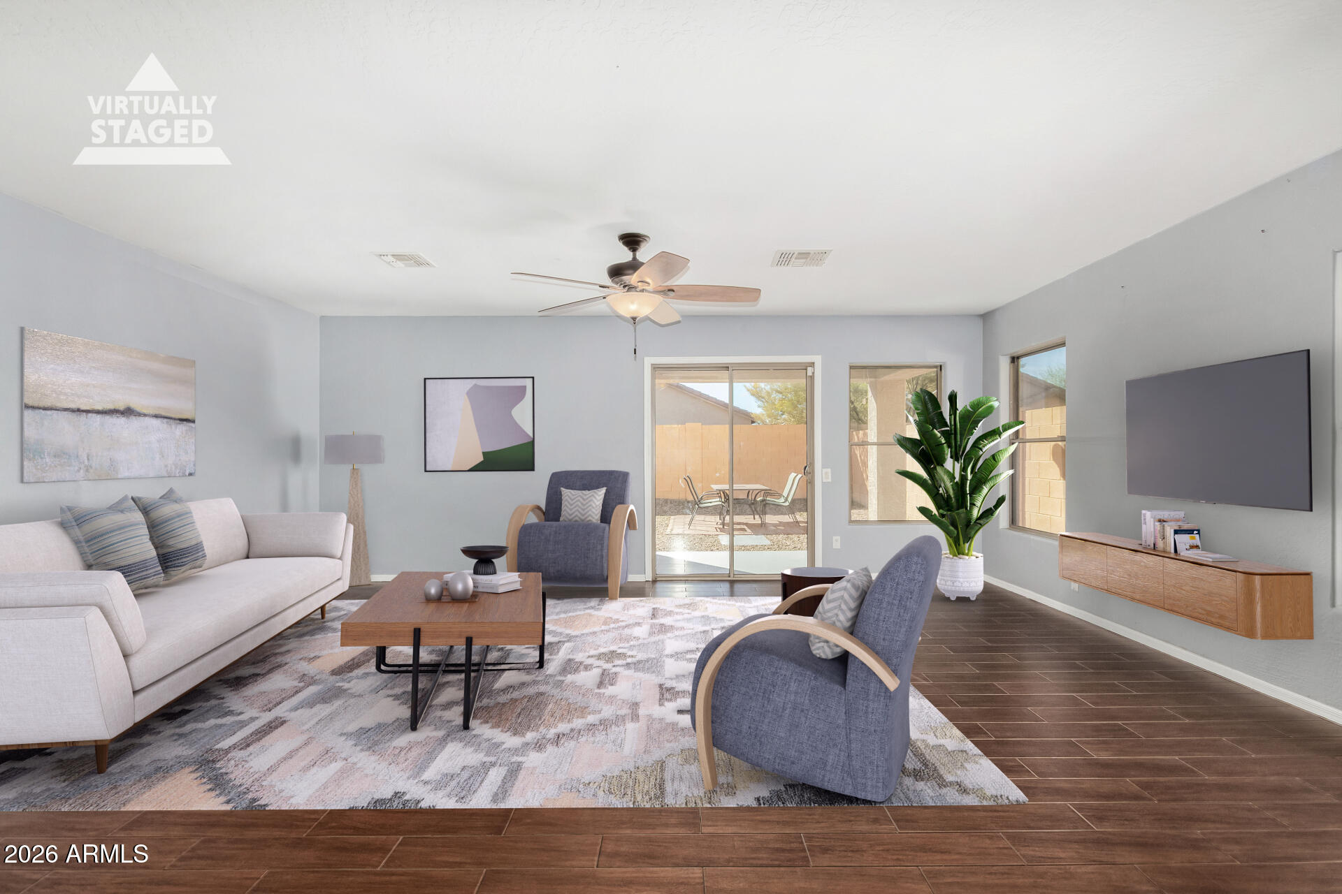 43845 West Elizabeth Avenue Maricopa, AZ 85138 - Photo 9 of 30 a living room with furniture and a wooden floor