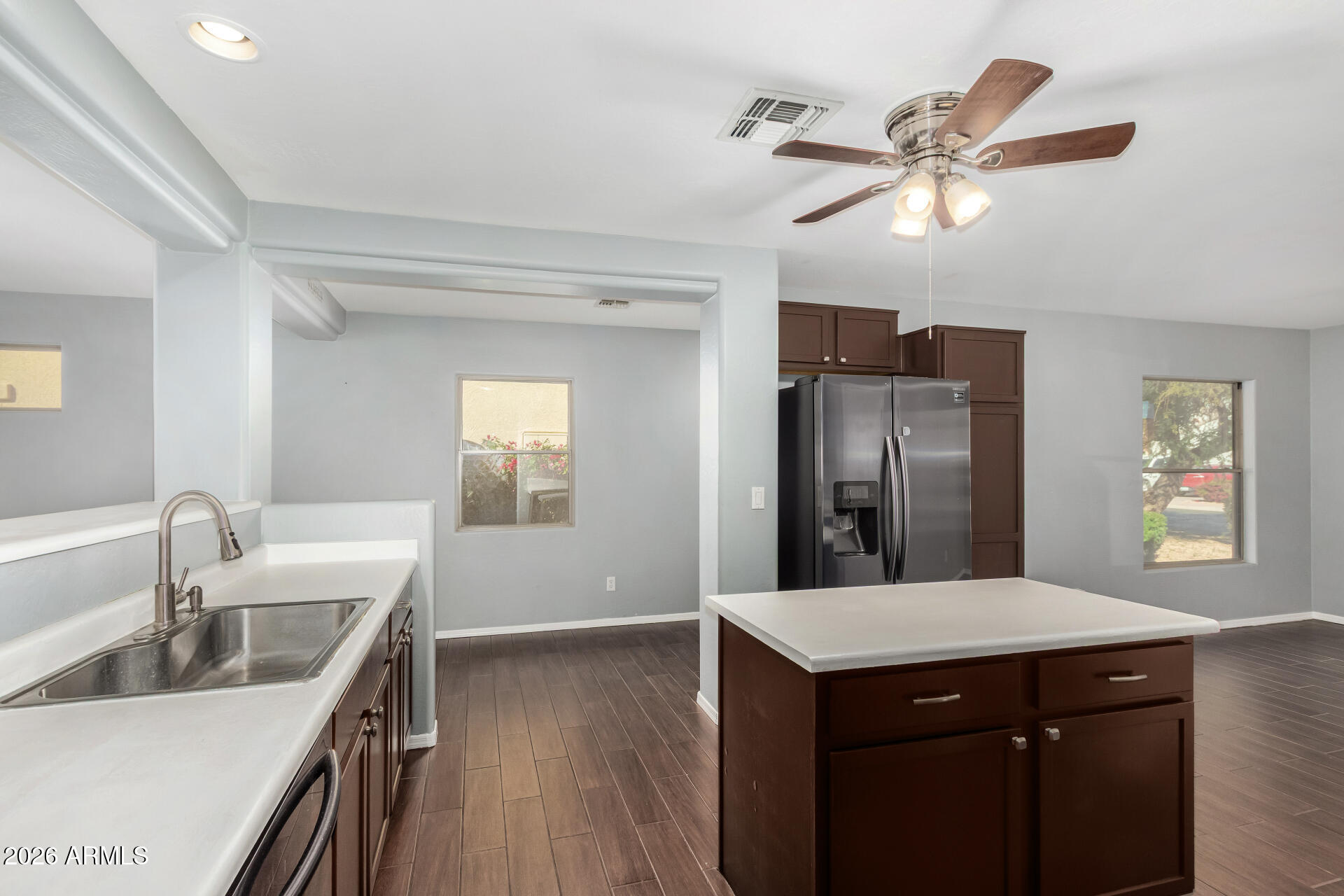 43845 West Elizabeth Avenue Maricopa, AZ 85138 - Photo 10 of 30 a kitchen with a center island and stainless steel appliances