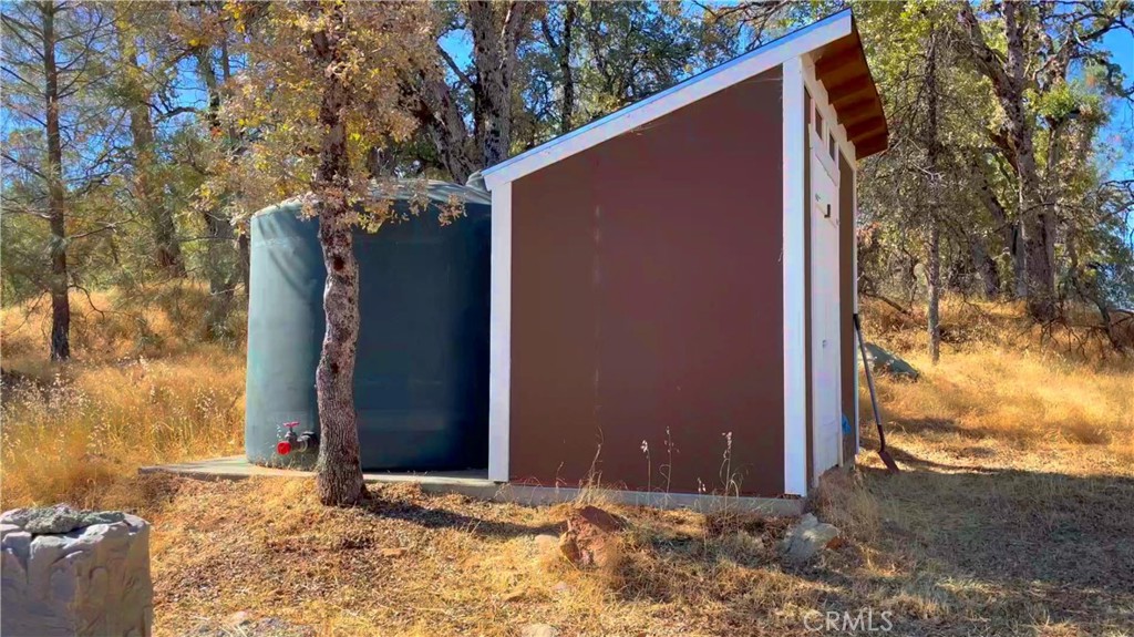 5341 Paddy Hill Road Mariposa, CA 95338 - Photo 10 of 20 a backyard of a house with trees and flowers